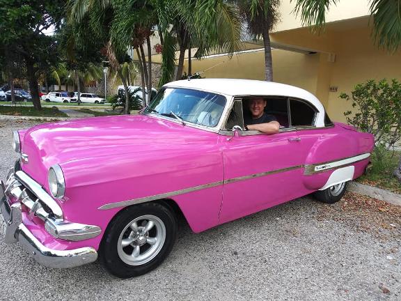 Jay Parnassa Shapiro in Cuba sitting in an old classic chevrolet